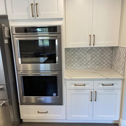 White cabinets with a Calacatta-look island — photo 16 of 19, by GT Stone and Cabinets Installation in South Amboy, NJ