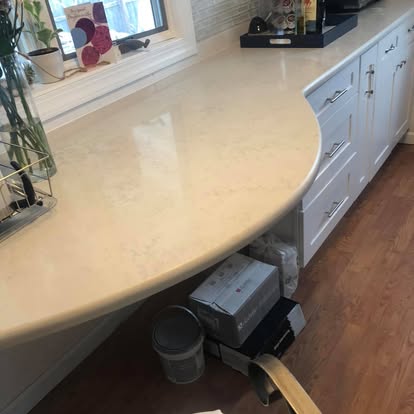 White kitchen with a curved breakfast bar — completed by GT Stone and Cabinets Installation in South Amboy, NJ