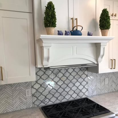 White kitchen, brass fixtures, arabesque backsplash — completed by GT Stone and Cabinets Installation in South Amboy, NJ